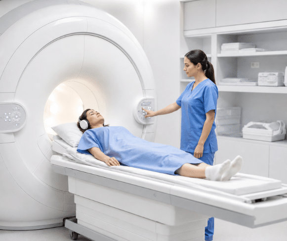 A patient lies on an MRI examination table while a healthcare professional assists with positioning inside the MRI scanner.